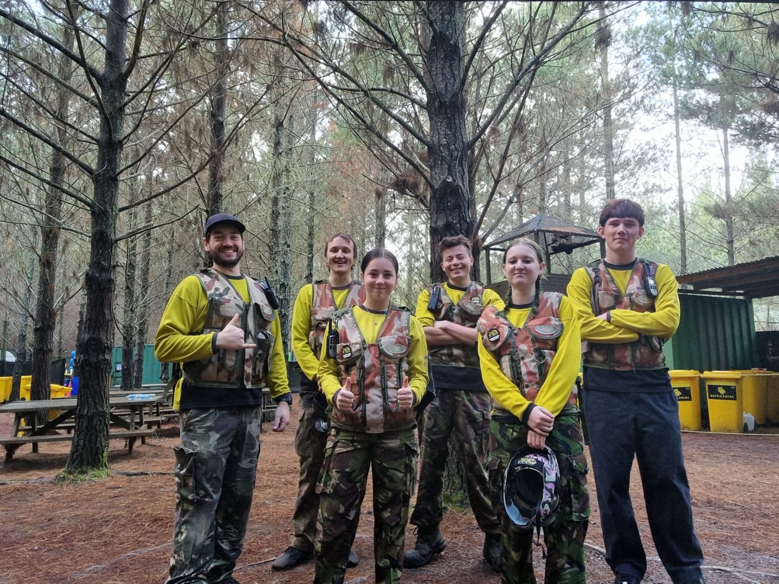 A six-person Delta Force marshal team together in woodland surroundings